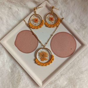 parure collier et boucles d'oreilles avec fleurs jaune orangées résinées et tissage perles